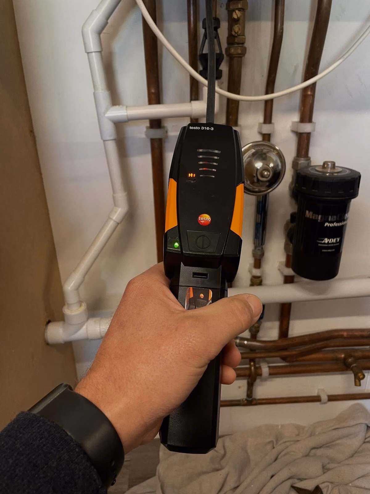 Electronic gas leak detector being used on boiler pipework