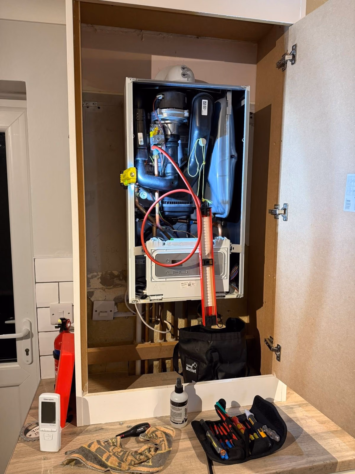 Boiler with its casing removed for internal inspection, tools laid out below